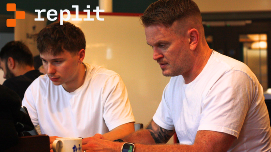 guy and harry from 3 sided cube testing replit at a hackathon