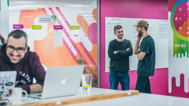 Image showcasing 3 Sided Cube's office, showing UK based developers collaborating.